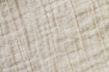 Beige natural cotton linen textile textured background. Clothes or kitchen tableclothの写真素材