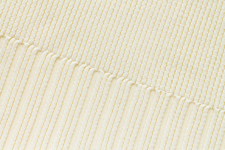 Textured background of beige knitted cotton or wool fabric pattern, close-upの写真素材