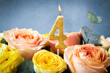 Gold glitter number 4 celebration candle with flowersの写真素材