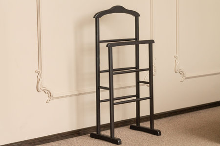 Wooden clothes rack in hotel roomの写真素材