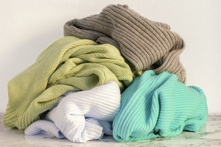 Heap of warm clothes on table, close-upの写真素材