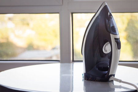 New electric steam iron on light backgroundの写真素材