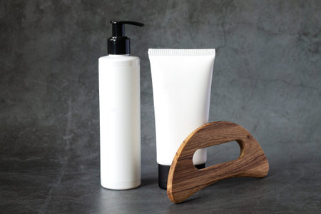 Set of anticellulite wooden massager and body care beauty products for spa procedureの写真素材