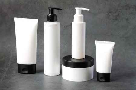 Skincare beauty products on dark marble background, set of cosmetics mock-up bottles and tubes for body careの写真素材