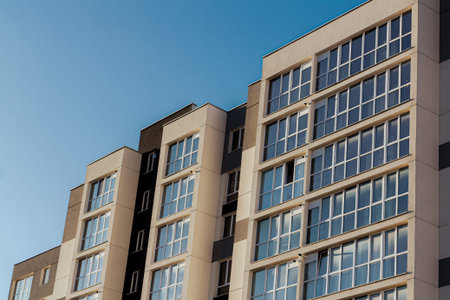 Modern apartment building on blue sky backgroundの写真素材
