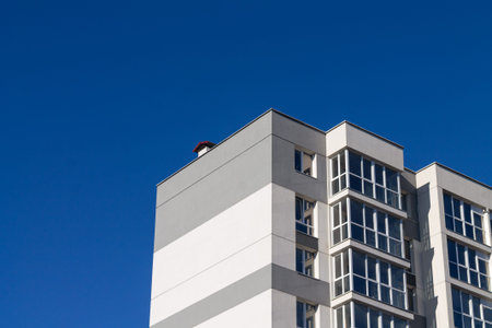 Modern apartment building on blue sky background