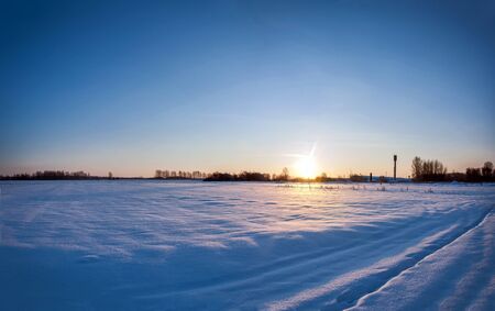 winter sunrise over the fieldの写真素材