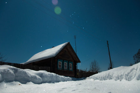 Old house in the moonlight in the snowの写真素材