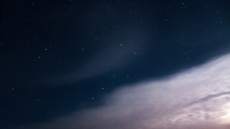 The constellation of a large bear on a beautiful, night, starry sky with clouds.の写真素材