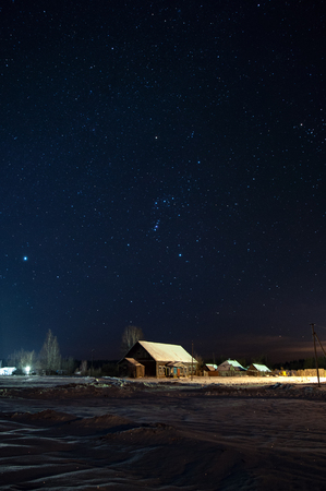 Constellation of Orion over an abandoned , old, rural club in Russian farms winter, frosty at night.の写真素材