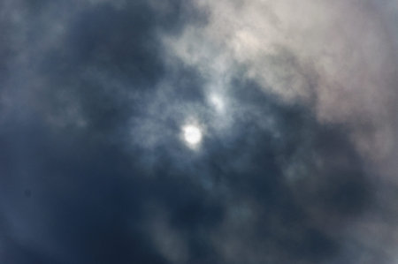 The gloomy sun glances through the clouds
