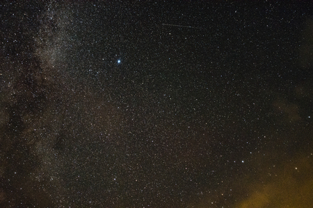 Stars through the clouds in the moonlight on a summer nightの写真素材