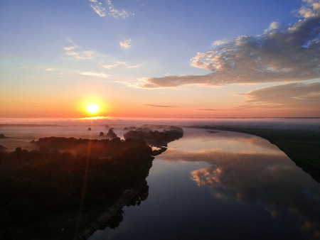 Beautiful view of the river from a height at dawn with fog summer morningの写真素材