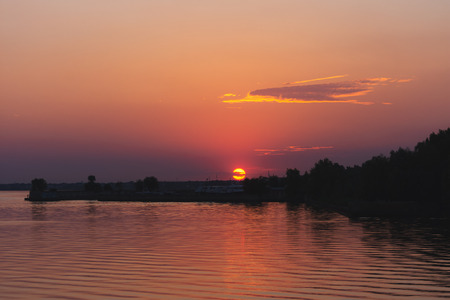Sunset over the waterの写真素材