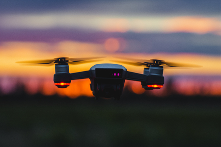The quadcopter on the background of a sunsetの写真素材