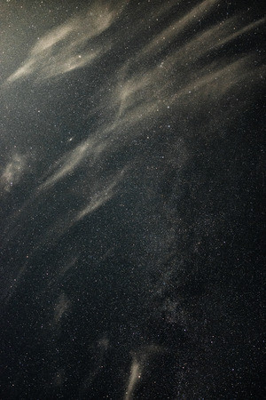 Clouds in the moonlight against the milky way summer nightの写真素材