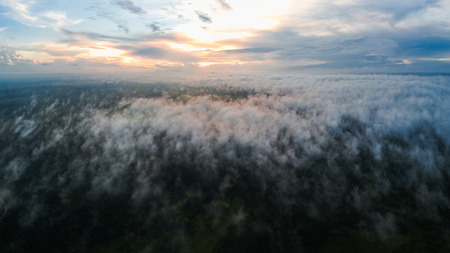 The view of the sunset above the clouds from the heightの写真素材