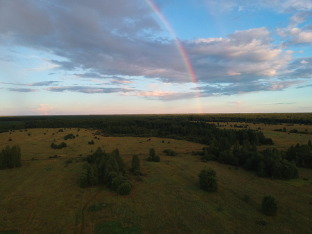 Rainbow over the forest from a heightの写真素材