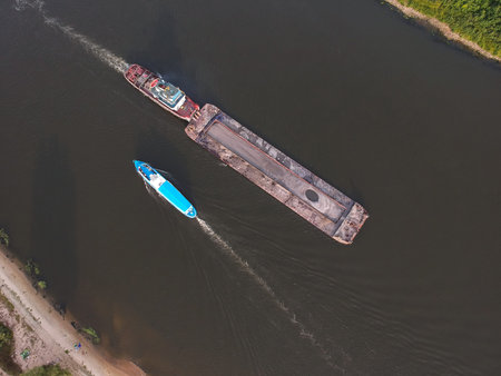 View from the height of a floating ship on the river, around the forest
