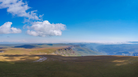Mountains with high altitude quadrocopter in summer, clouds and fields aroundの写真素材