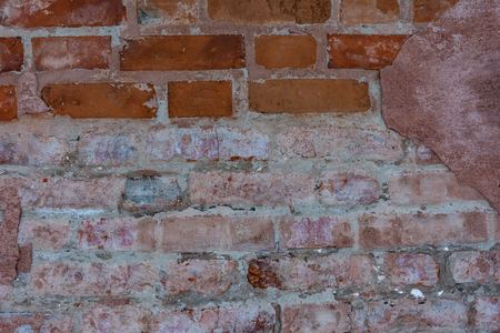 Texture of red brickwork with peeled white paintの写真素材