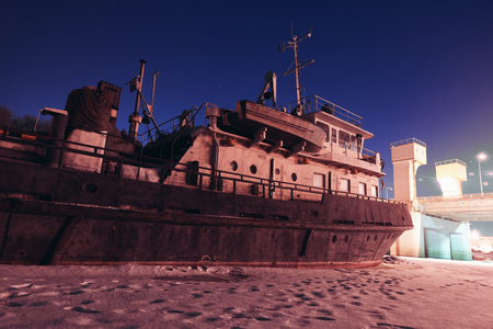 Old abandoned ship in winter nightの写真素材