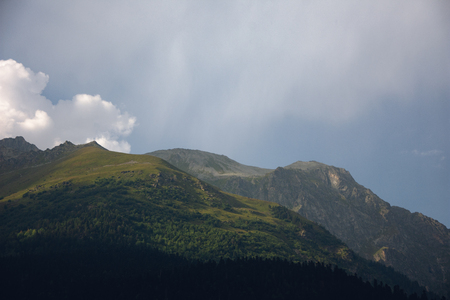 Large panorama Massive Caucasian mountains in the surroundings of dombai in the clouds. Summer day.の写真素材