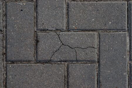 Macro texture of cracked paving slabs. One bad among normalの写真素材