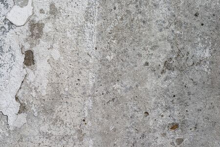 Macro texture of peeled paint on a white concrete wall.の写真素材