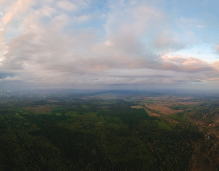 Large panorama of clouds over forests, fields and villages in Russia from the height of the quadrocopter of rainの写真素材