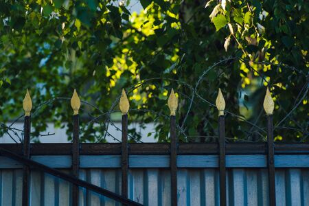 Fence with pikes and barbed wireの写真素材