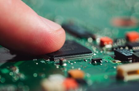 Macro photo touched a finger to a laptop chip close upの写真素材
