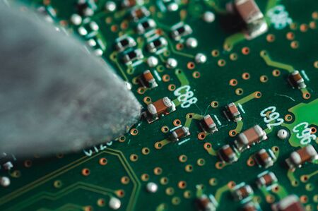 Macro photo of a knife touched a laptop chip close-upの写真素材