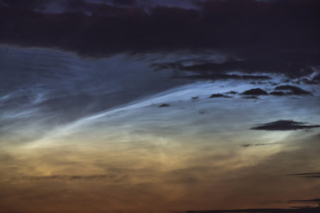 Noctilucent clouds closeup summer night. Rare atmospheric phenomenon