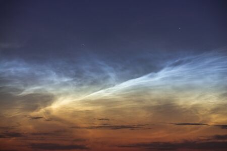 Noctilucent clouds closeup summer night. Rare atmospheric phenomenonの写真素材