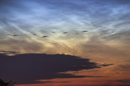 Noctilucent clouds closeup summer night. Rare atmospheric phenomenon