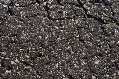 Macro texture of old cracked asphaltの写真素材