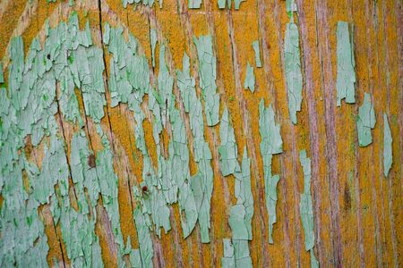 Wall texture of wooden boards with peeling green paint close-upの写真素材