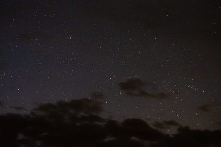 Stars in the night sky through the clouds