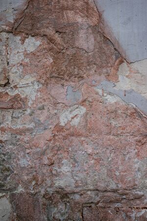 Macro texture of an old red brick wall and even separation of fallen plasterの写真素材