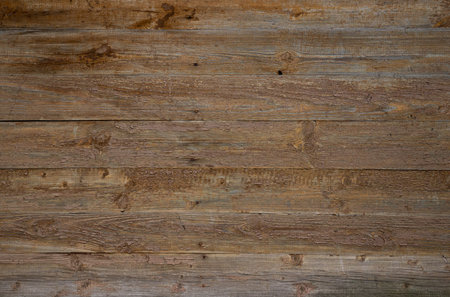 Texture of old wooden wall with peeling beige paint from boardsの写真素材