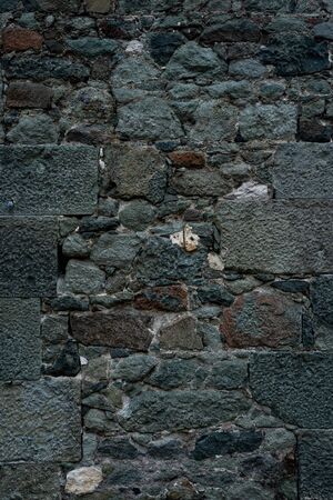 Texture of stone wall made of grey stonesの写真素材