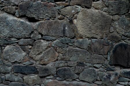 Texture of stone wall made of grey stonesの写真素材