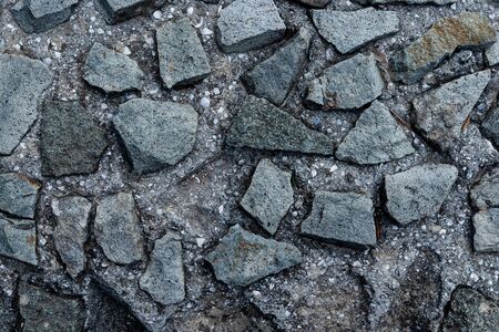Texture of stone wall made of grey stonesの写真素材