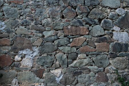 Texture of stone wall made of grey stonesの写真素材