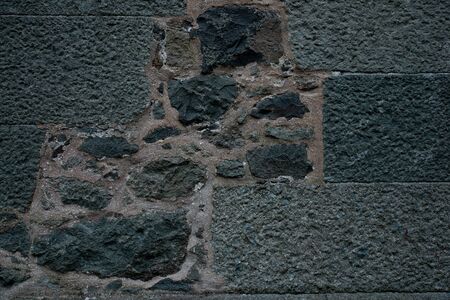 Texture of stone wall made of grey stonesの写真素材