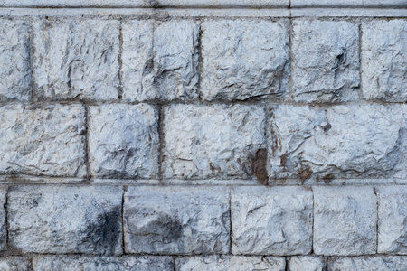 Texture of stone wall made of grey stones