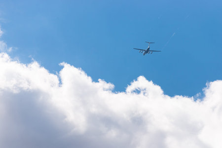 A large plane flies into the clouds