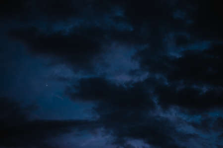 Stars in the night sky bring the clouds togetherの写真素材