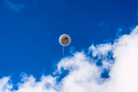 Flying in the blue sky with clouds balloonの写真素材